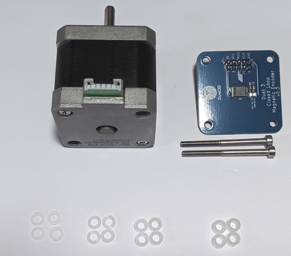 Image showing the Nema 17 motor with two of the 4 bolts through the back of the motor removes, also shown are the Magnetic encoder PCB, two long M3 bolts and 4 sets of nylon washers of different thicknesses.