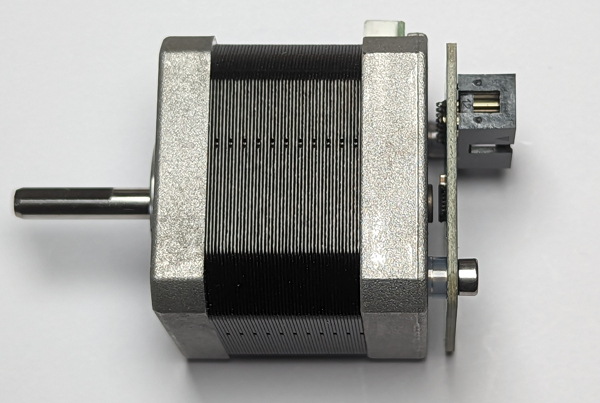 Image showing the encoder board fitted to the back of the motor using nylon spacers and the longer M3 bolts. the image shows that the Magnetic encoder chip mounted on the baord is ~1mm for the magnet.